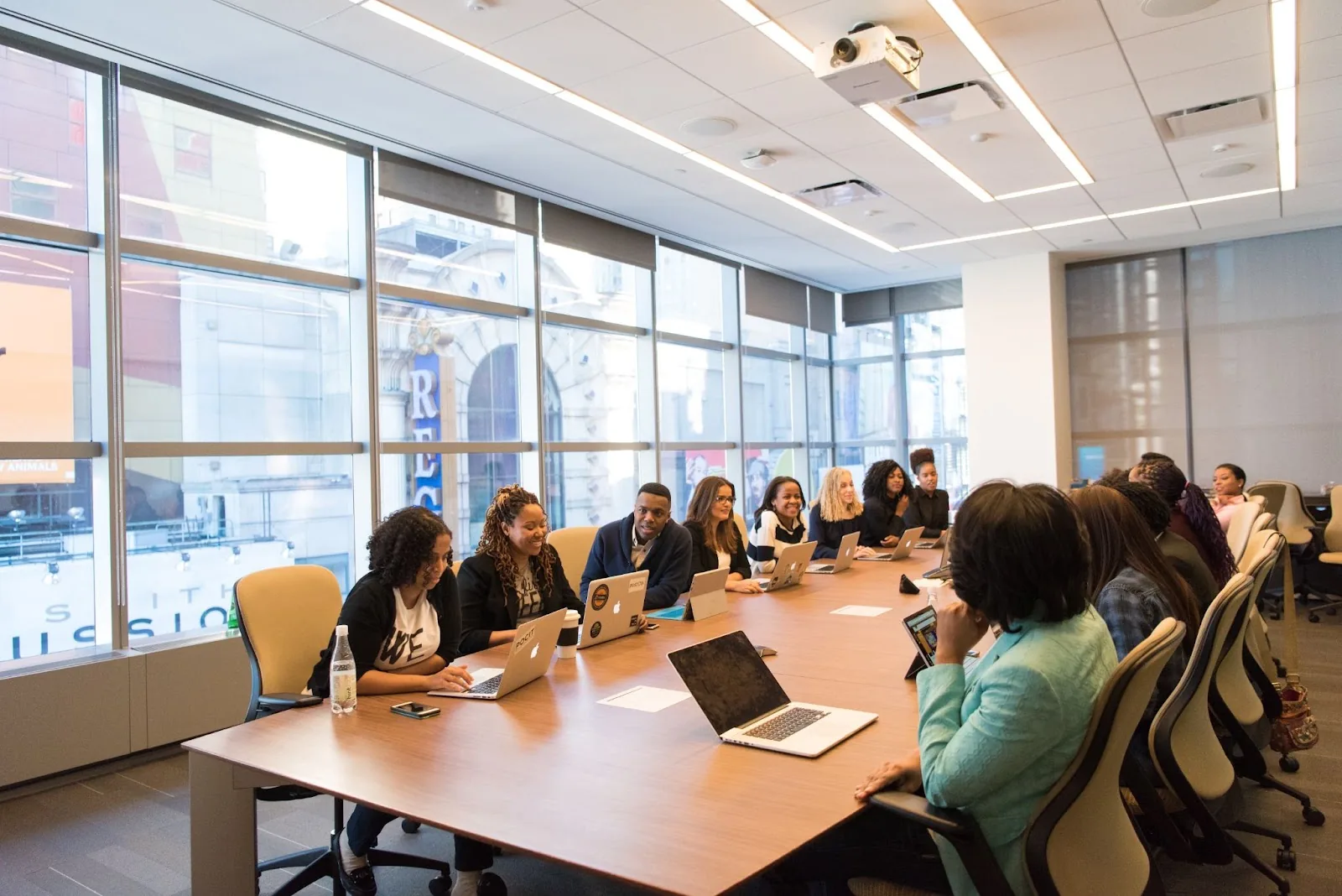 Diverse team seated around a long conference table in a meeting