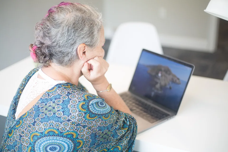 Experienced employee upskilling through an online course on her laptop