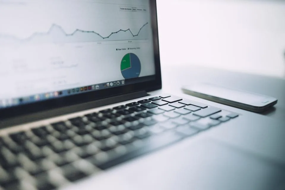 Laptop showing an analytics dashboard with charts, representing an integrated learning platform